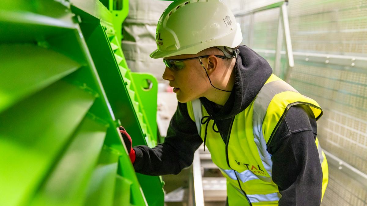Industrial worker in a hard hat and high-visibility safety vest on a UAE work site